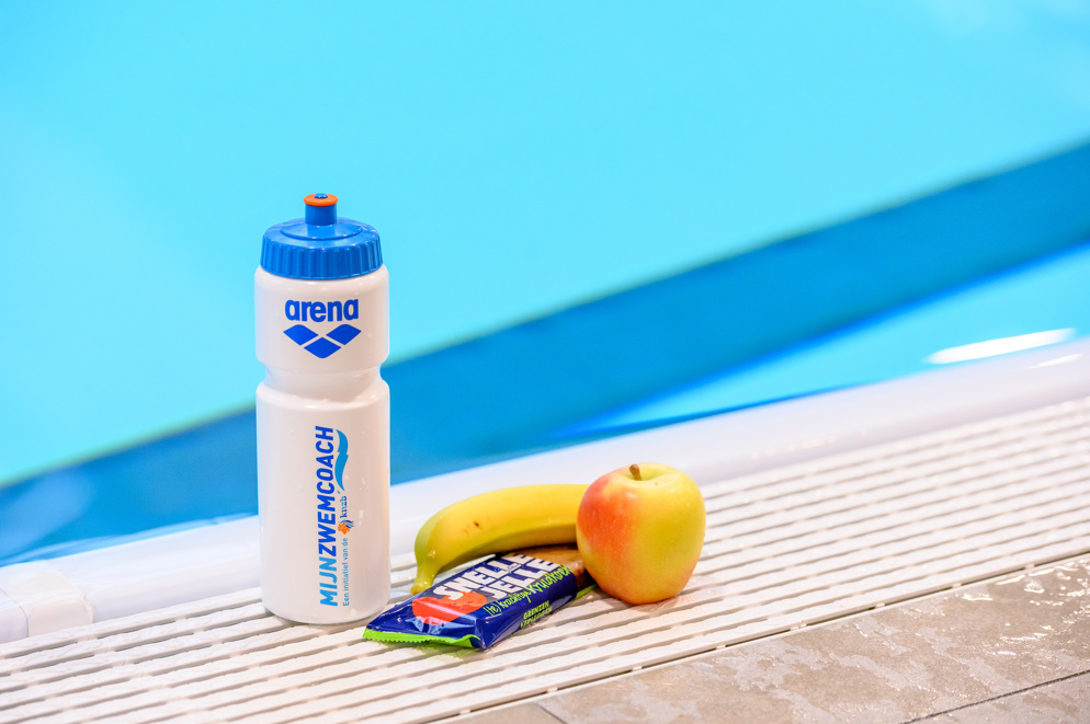 Op de kant staat een bidon, appel, banaan en snelle jelle